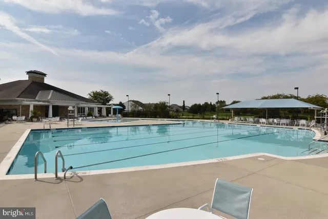 a view of a patio with couches table and chairs and potted plants