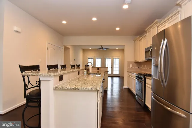 a kitchen with sink refrigerator and microwave