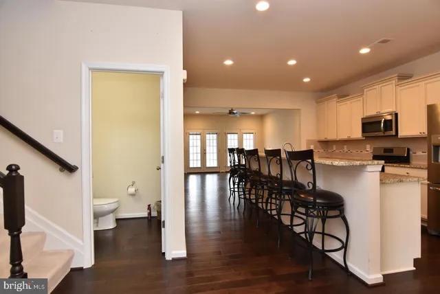 a dining room with furniture and wooden floor