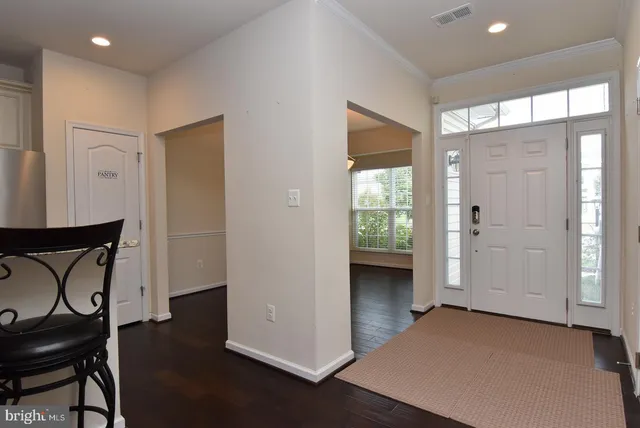 a view of an entryway with wooden floor