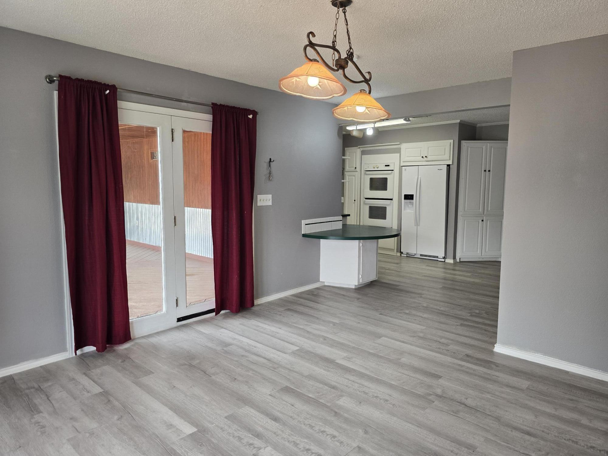 506 North 19th Street Lamesa, TX 79331 - Photo 12 of 29 a view of a room with a cabinet and a chandelier