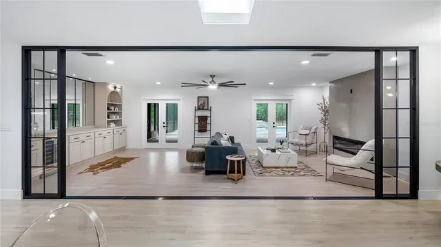 a living room with furniture and view of kitchen