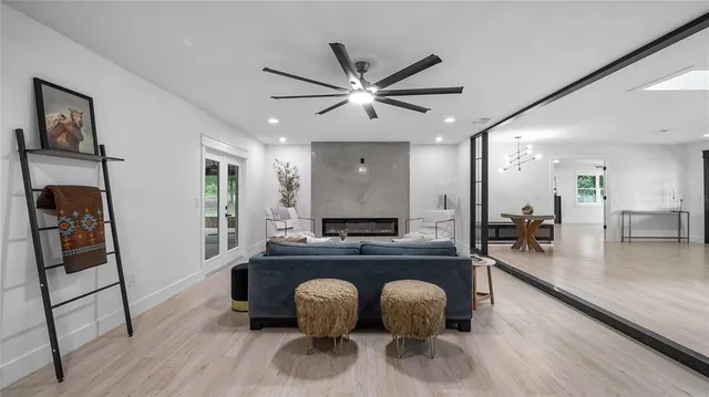 a living room with furniture and a table with wooden floor