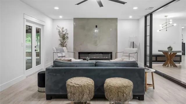 a living room with furniture a large window and a flat screen tv