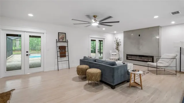 a view of an empty room with a window and a kitchen