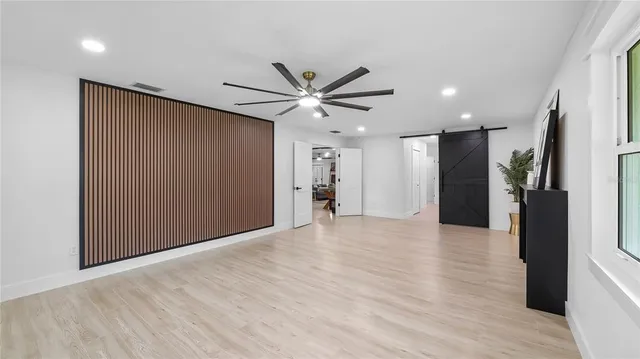 a view of empty room with wooden floor