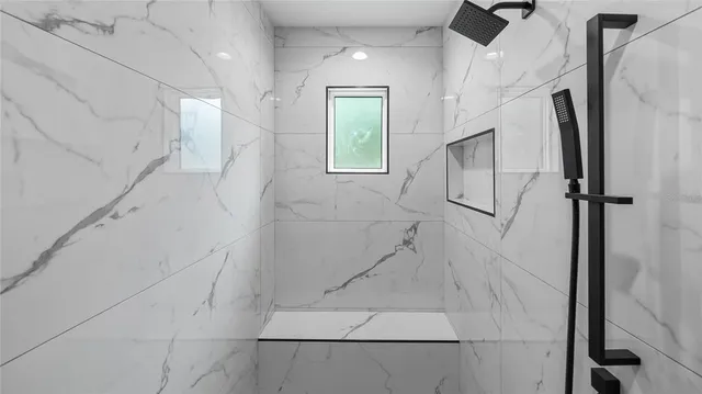 a bathroom with a granite countertop sink and a toilet