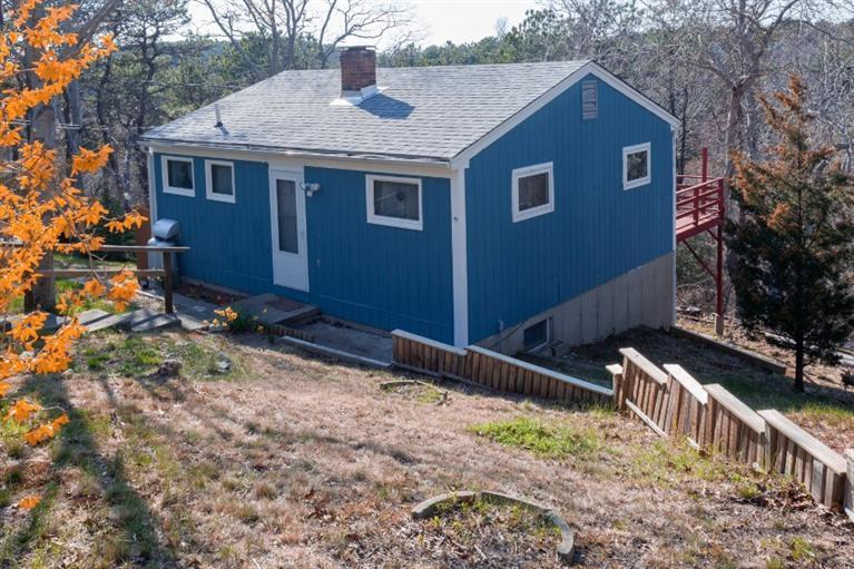 11 Josephs Road Truro, MA 02666 - Photo 1 of 19 a front view of house with yard and trees around