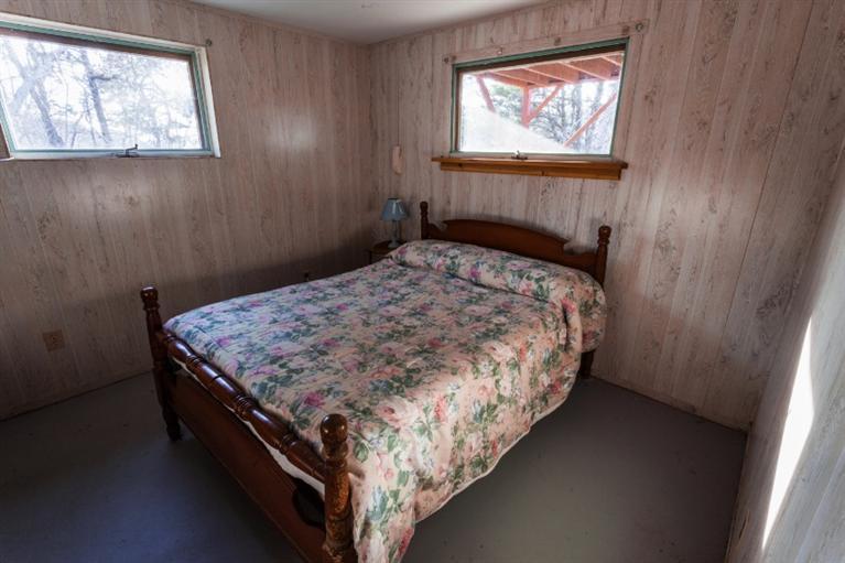 11 Josephs Road Truro, MA 02666 - Photo 15 of 19 a bed sitting in a bedroom next to a window