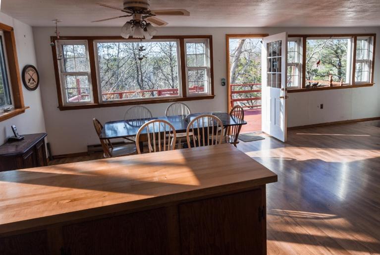 11 Josephs Road Truro, MA 02666 - Photo 10 of 19 a view of a dining room with furniture a chandelier and wooden floor