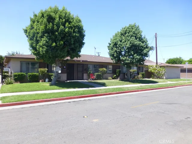 a house view with garden space and trees