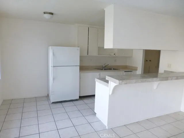 a utility room with cabinets washer and dryer