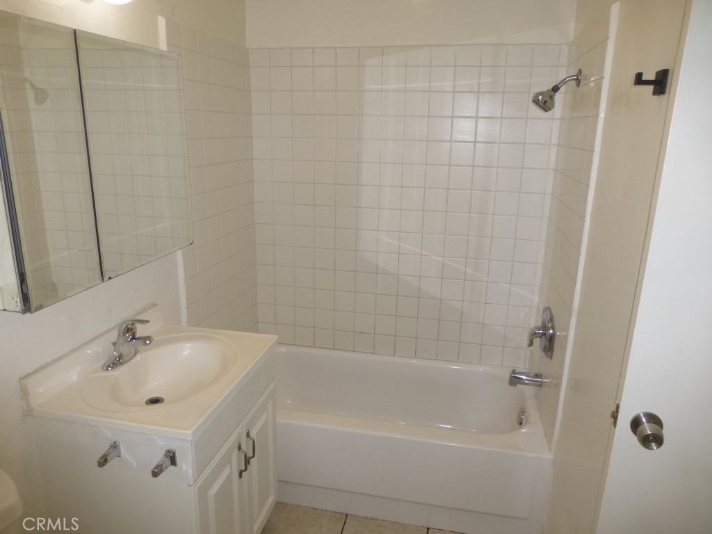 2115 Broden Street Anaheim, CA 92802 - Photo 21 of 23 a bathroom with a bathtub a sink a toilet and a mirror