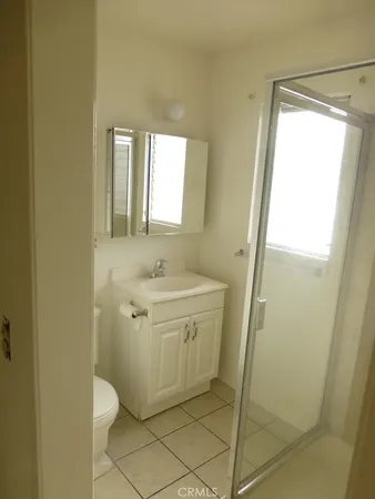 a bathroom with a sink a mirror and a shower