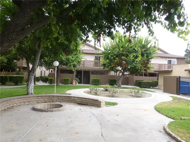 a view of a backyard with a patio table and chairs