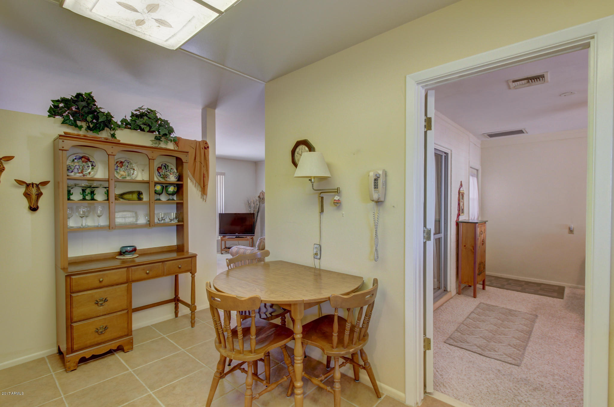 10008 West Riviera Drive Sun City, AZ 85351 - Photo 14 of 26 a dining room with a table and chairs