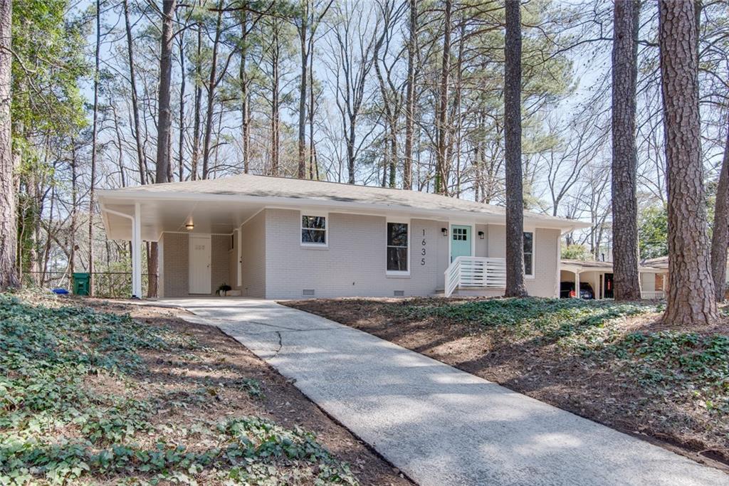 1635 Delia Drive Decatur, GA 30033 - Photo 1 of 1 a front view of a house with a yard and trees