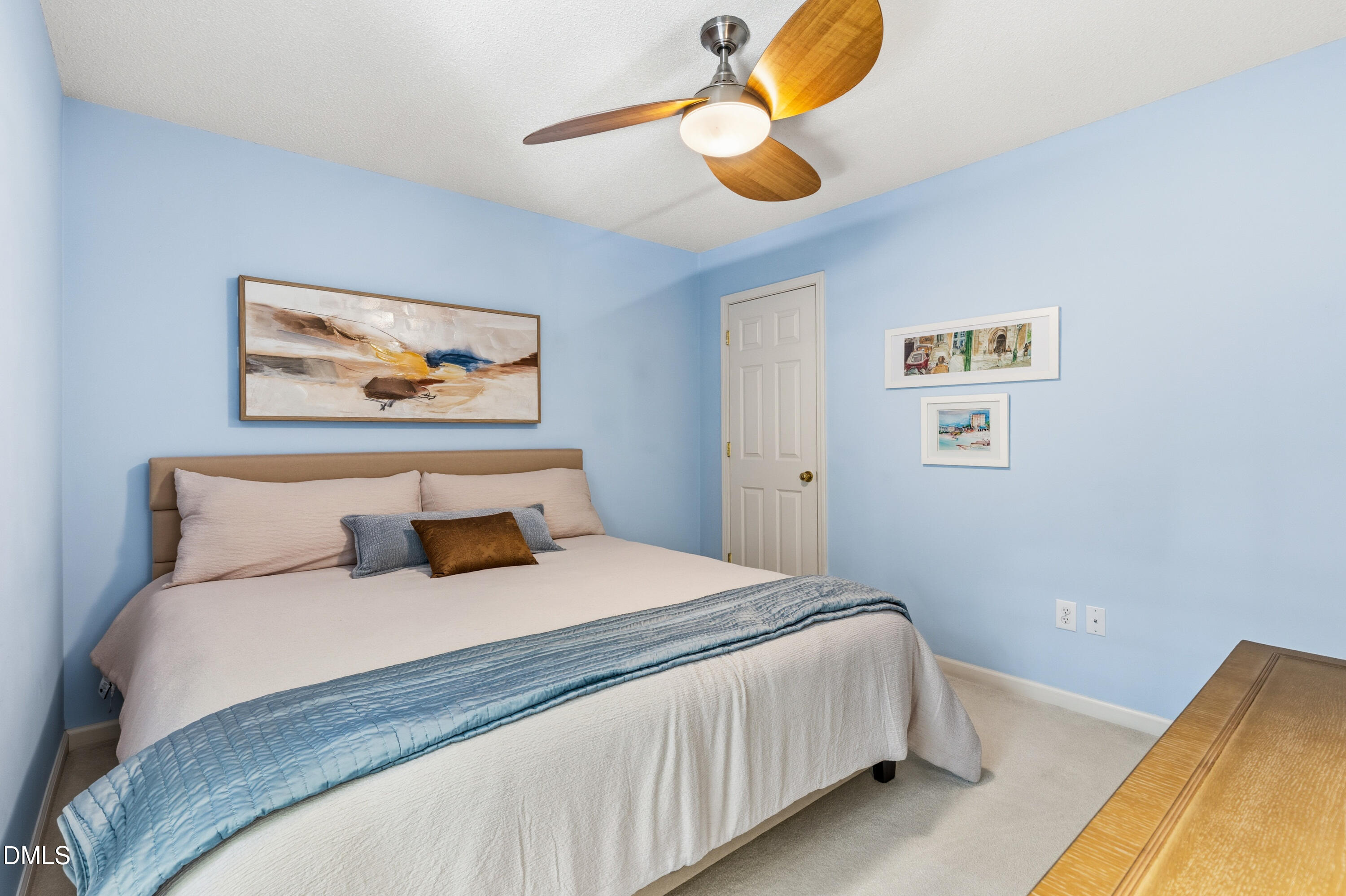 1211 Waterford Green Drive Apex, NC 27502 - Photo 38 of 53 a bedroom with a bed and painting on the wall