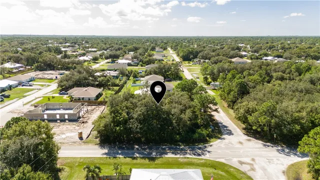 an aerial view of residential houses with outdoor space and swimming pool