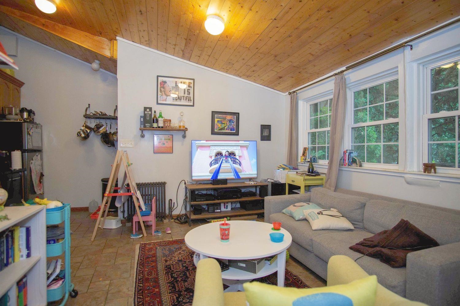 334 Paterson Plank Road, Unit 1 Jersey City, NJ 07307 - Photo 2 of 20 a living room with furniture and a flat screen tv