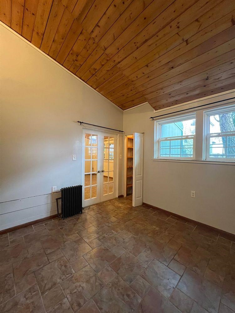 334 Paterson Plank Road, Unit 1 Jersey City, NJ 07307 - Photo 6 of 20 a view of an empty room with wooden floor and windows