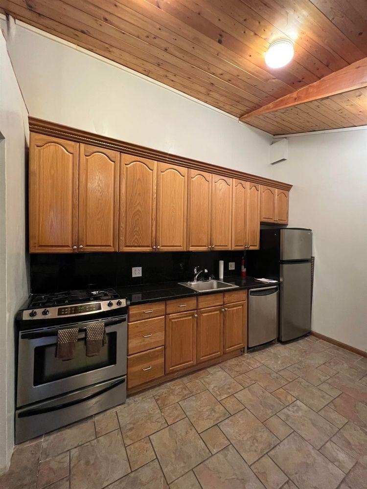 334 Paterson Plank Road, Unit 1 Jersey City, NJ 07307 - Photo 10 of 20 a kitchen with stainless steel appliances a stove a sink and a microwave