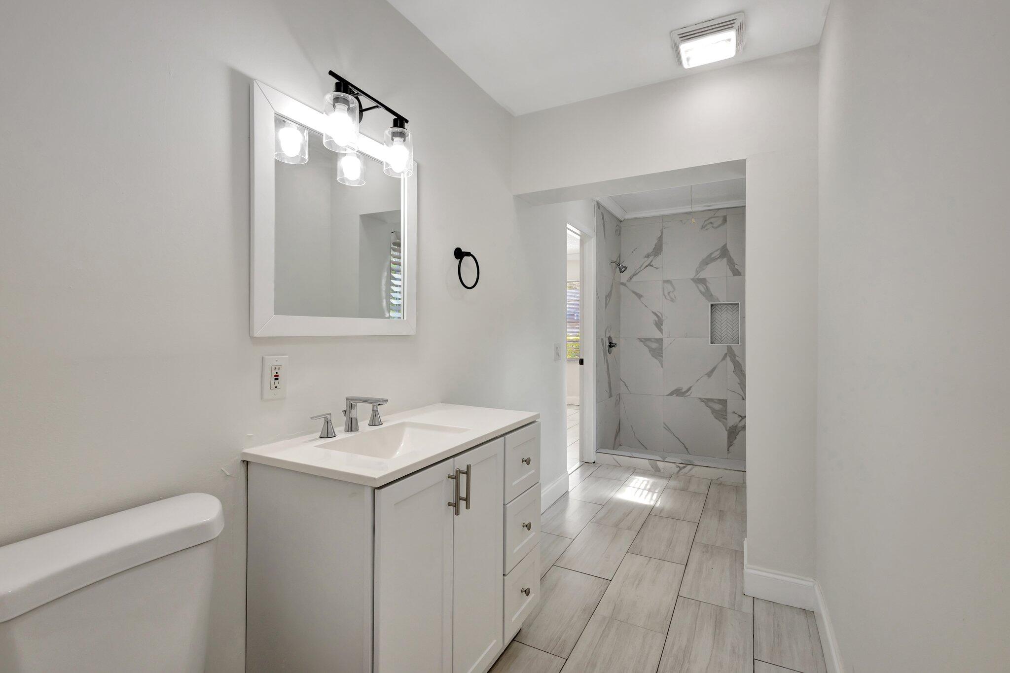 1225 16th Avenue North Lake Worth Beach, FL 33460 - Photo 13 of 18 a bathroom with a sink a toilet and shower