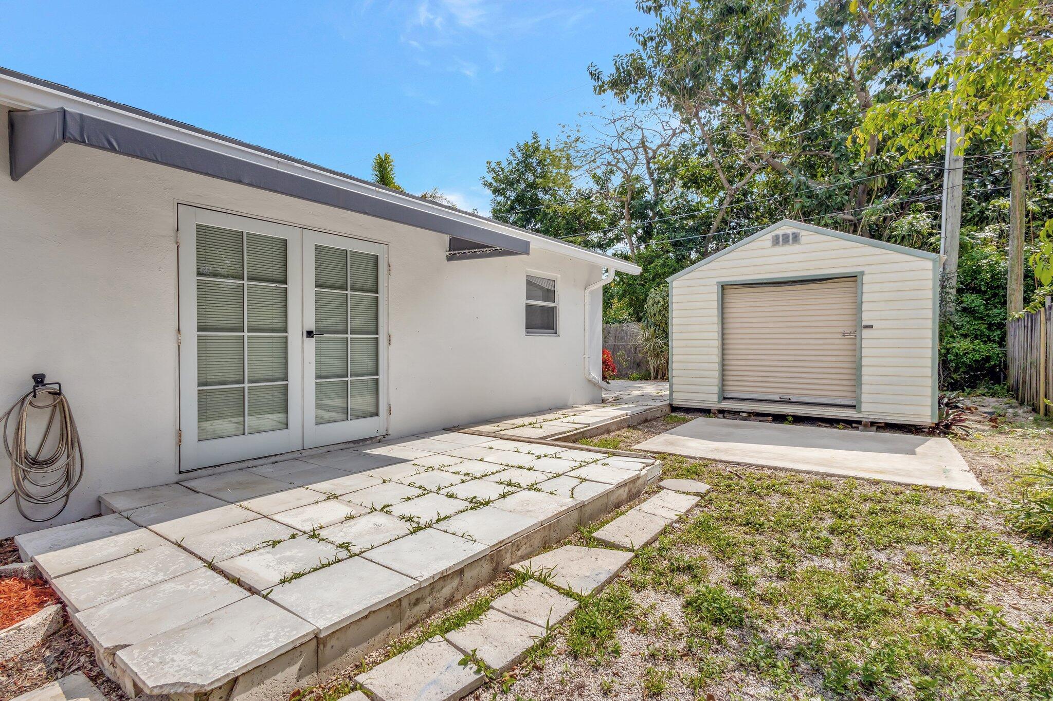 1225 16th Avenue North Lake Worth Beach, FL 33460 - Photo 16 of 18 a front view of a house with a yard