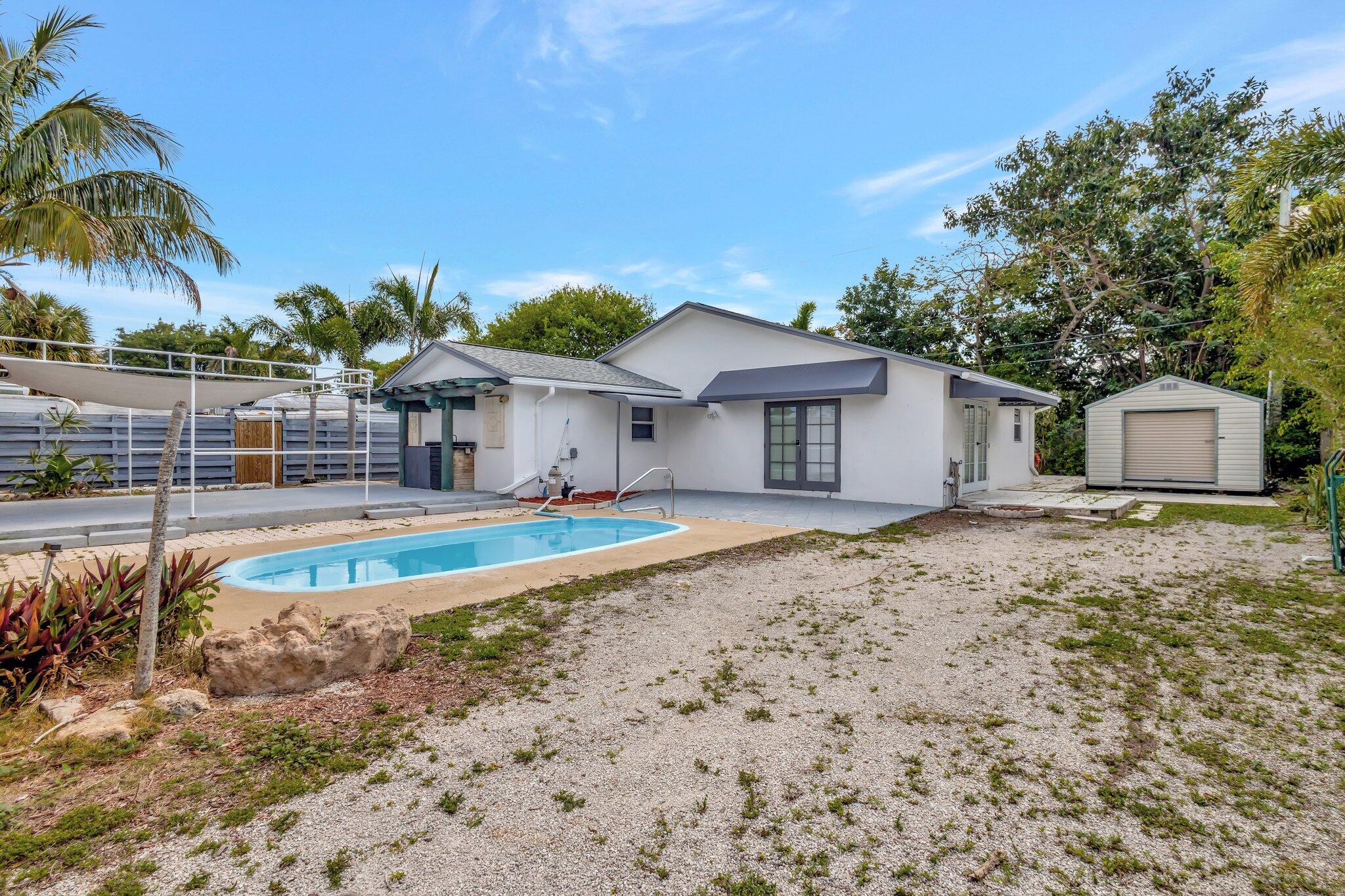 1225 16th Avenue North Lake Worth Beach, FL 33460 - Photo 17 of 18 a front view of a house with a yard