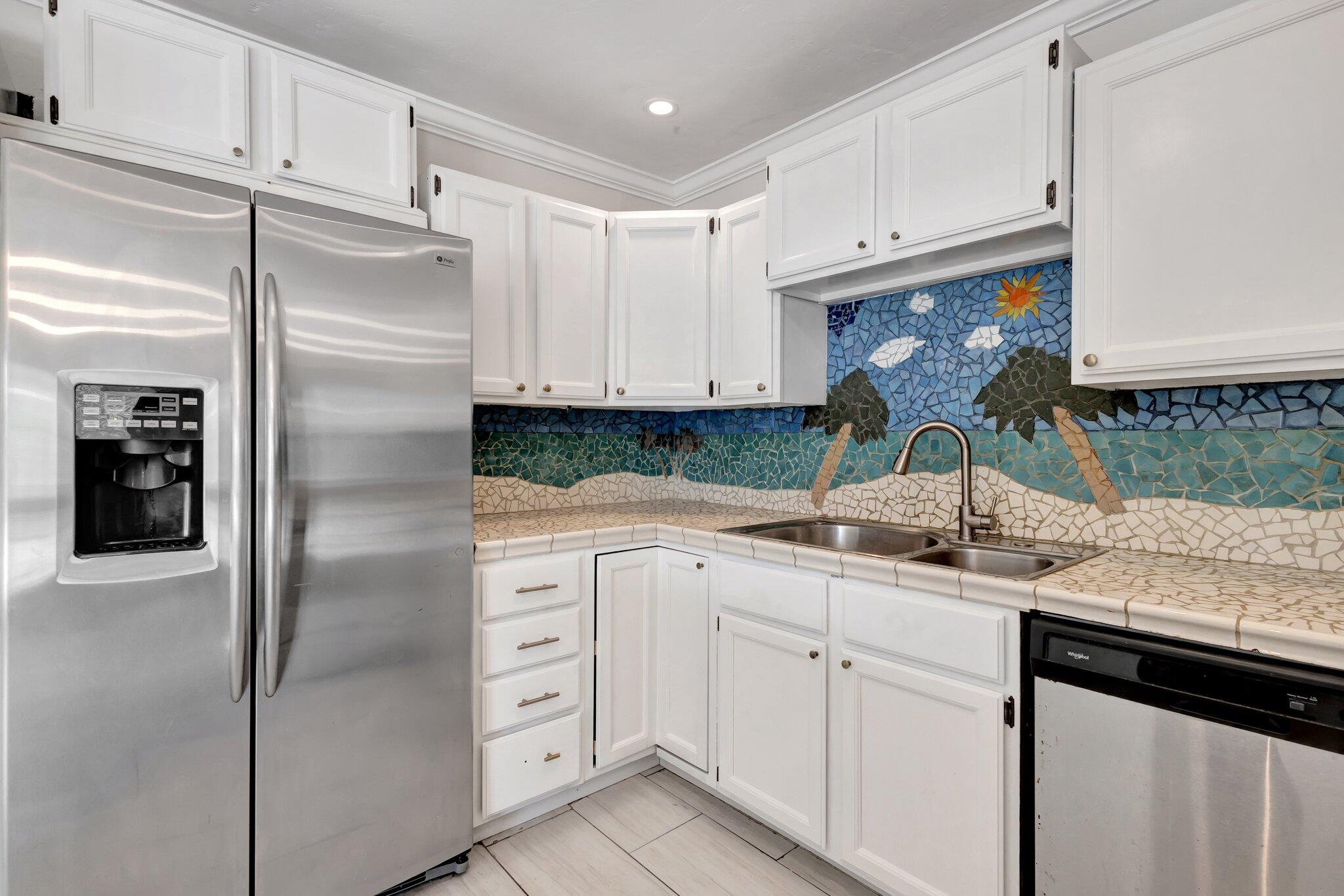 1225 16th Avenue North Lake Worth Beach, FL 33460 - Photo 2 of 18 a kitchen with white cabinets and refrigerator