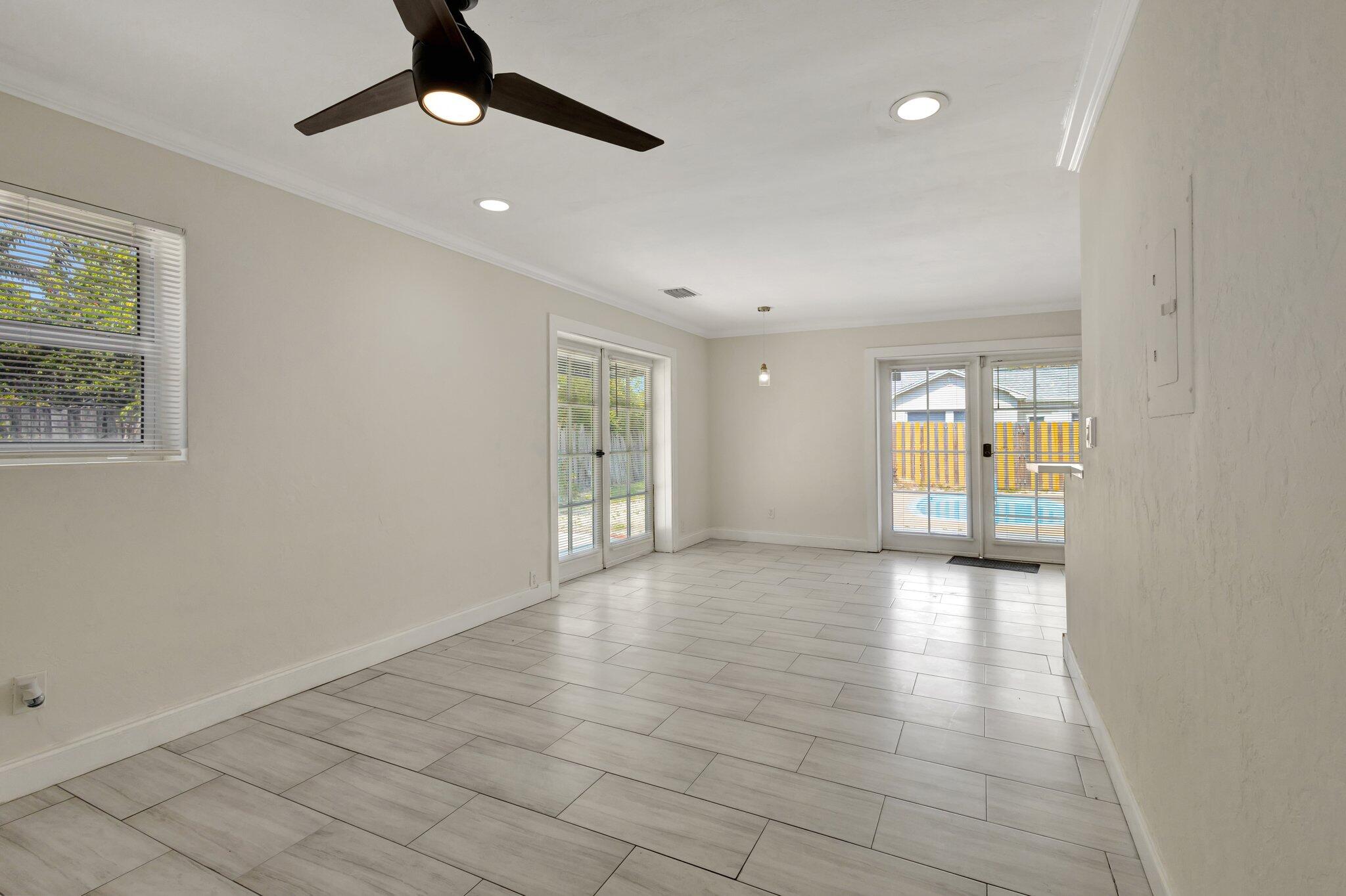 1225 16th Avenue North Lake Worth Beach, FL 33460 - Photo 4 of 18 a view of an empty room with window and chandelier fan
