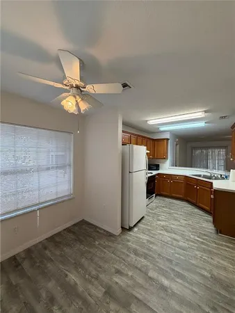 a view of a kitchen with wooden floor and a window