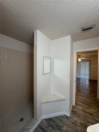 a view of a hallway with wooden floor