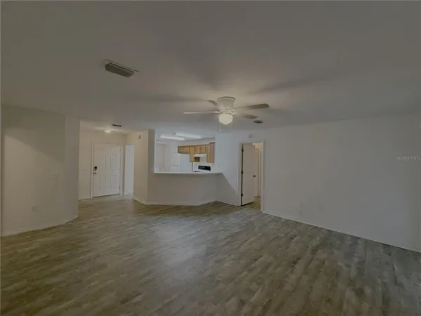 an empty room with a empty space and windows