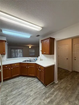 a kitchen with stainless steel appliances granite countertop a sink and a stove