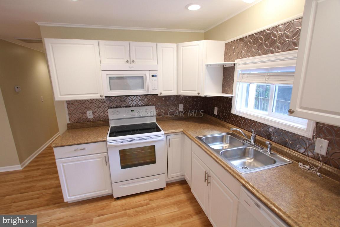68 Sandyhook Road Ocean Pines, MD 21811 - Photo 12 of 35 a kitchen with a stove a sink and a microwave