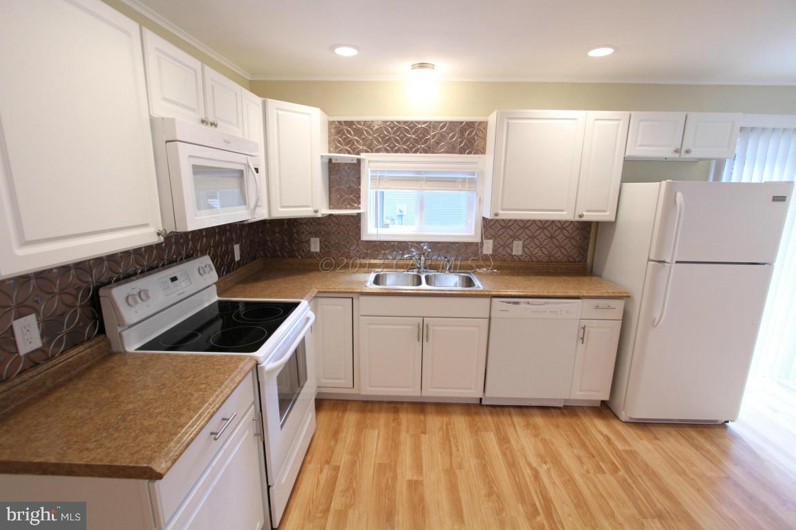 68 Sandyhook Road Ocean Pines, MD 21811 - Photo 13 of 35 a kitchen with granite countertop a sink a counter top space stainless steel appliances and cabinets