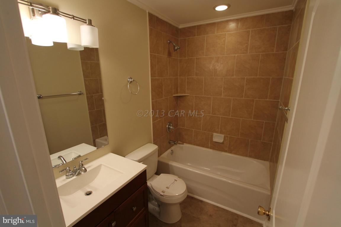 68 Sandyhook Road Ocean Pines, MD 21811 - Photo 20 of 35 a bathroom with a bathtub shower sink vanity and toilet