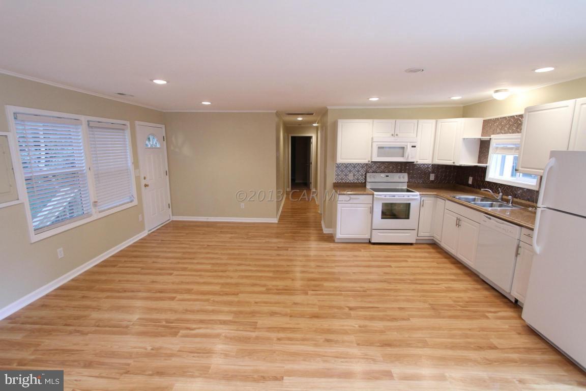 68 Sandyhook Road Ocean Pines, MD 21811 - Photo 3 of 35 a large kitchen with stainless steel appliances granite countertop a stove a sink and a refrigerator