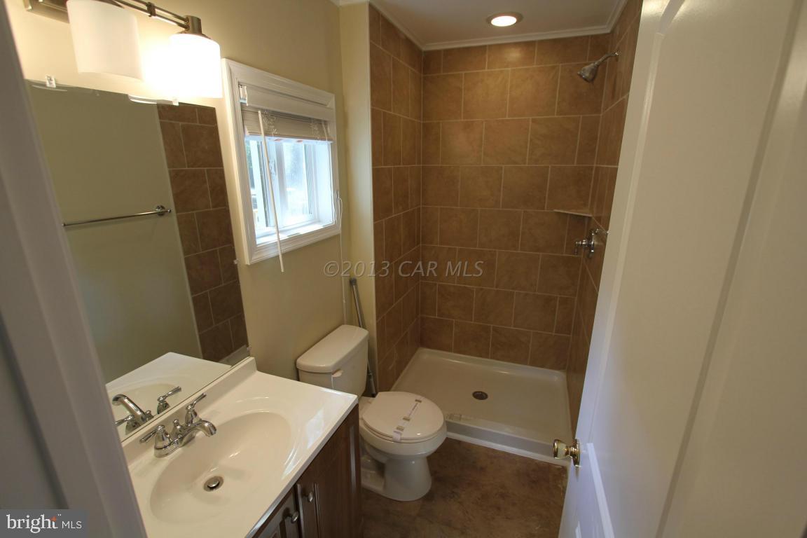 68 Sandyhook Road Ocean Pines, MD 21811 - Photo 21 of 35 a bathroom with a bathtub shower sink and toilet