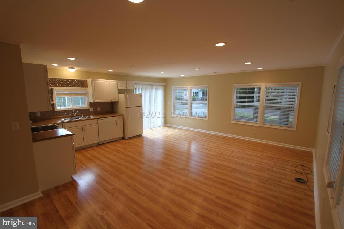68 Sandyhook Road Ocean Pines, MD 21811 - Photo 9 of 35 a view of an empty room with window and wooden floor