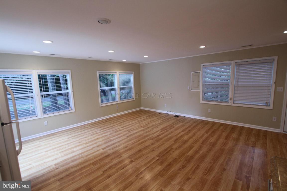 68 Sandyhook Road Ocean Pines, MD 21811 - Photo 10 of 35 a view of an empty room with wooden floor and a window