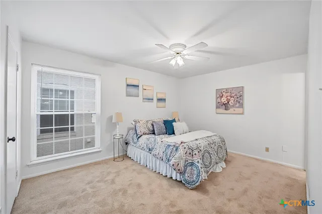 a spacious bedroom with a bed and a window