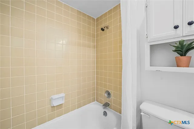 a bathroom with a shower and a toilet