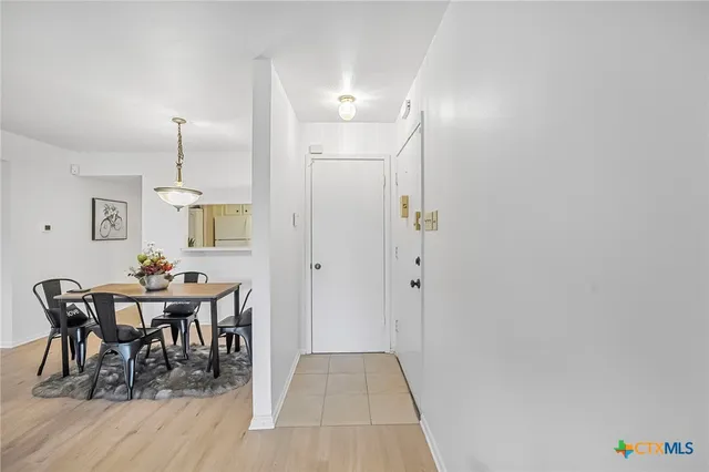 a view of a dining room with furniture and chandelier