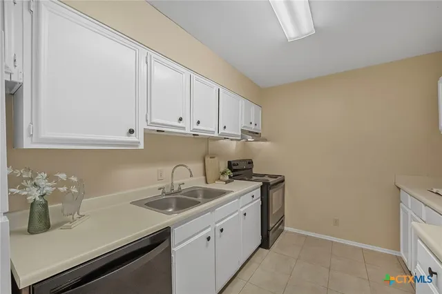 a kitchen with a sink and cabinets