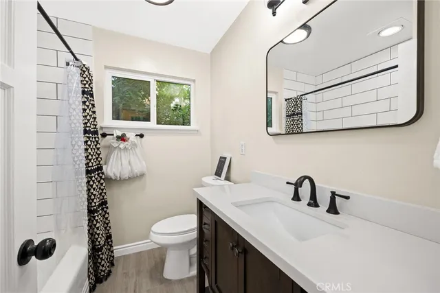 a bathroom with a sink a toilet and mirror