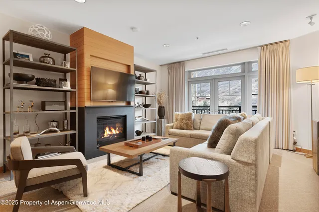 a living room with furniture fireplace and a window
