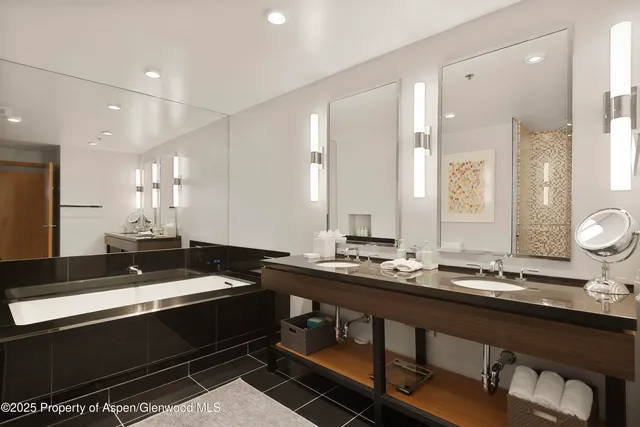 a large bedroom with a bed and glass window