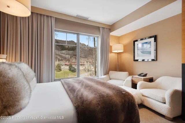 a spacious bedroom with a bed and window